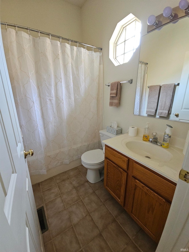 bathroom featuring vanity, toilet, and tile patterned floors