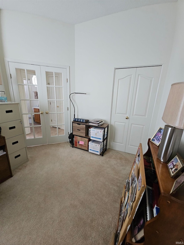 miscellaneous room with light colored carpet and french doors