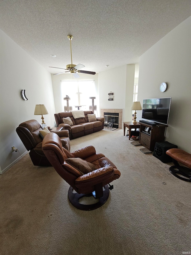 living room featuring a wealth of natural light, carpet, ceiling fan, and a fireplace