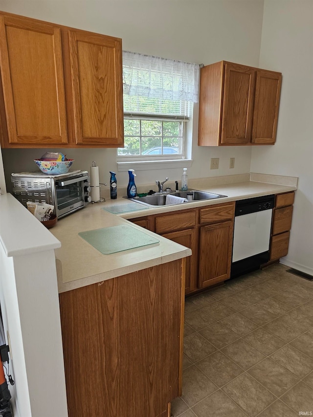 kitchen featuring white dishwasher and sink