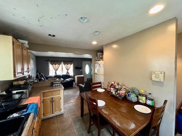 kitchen with white fridge and tile patterned floors