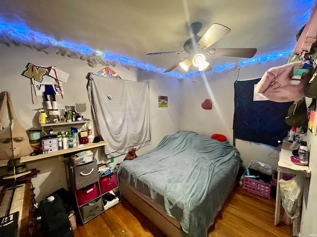 bedroom featuring ceiling fan and wood-type flooring