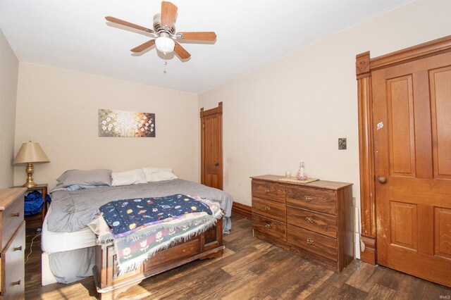 bedroom with ceiling fan and dark hardwood / wood-style floors