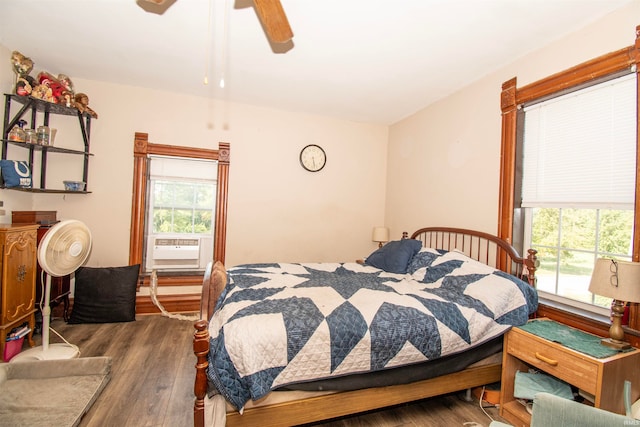 bedroom with wood-type flooring, cooling unit, and ceiling fan