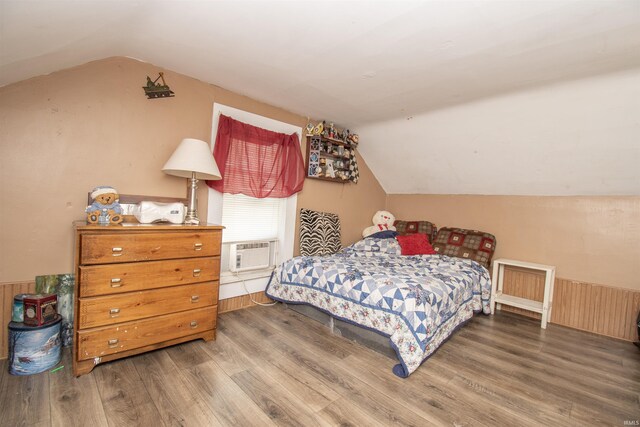 bedroom with lofted ceiling and dark hardwood / wood-style flooring