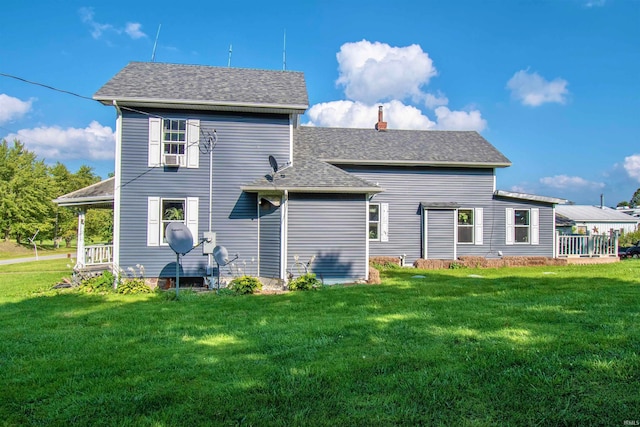 rear view of property with a yard and cooling unit