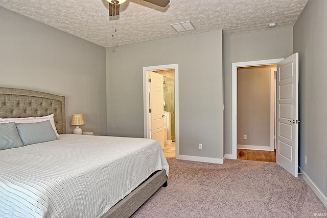 carpeted bedroom with ceiling fan, ensuite bathroom, and a textured ceiling