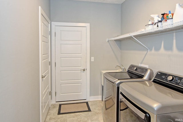 washroom with washer and dryer and light tile patterned floors