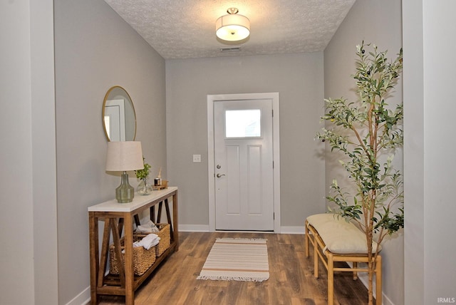 foyer entrance with a textured ceiling and hardwood / wood-style flooring