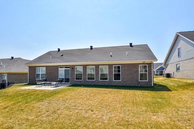 rear view of property featuring a patio area and a yard