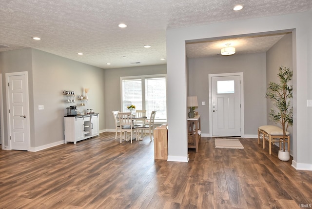 entrance foyer featuring dark wood-type flooring and a textured ceiling