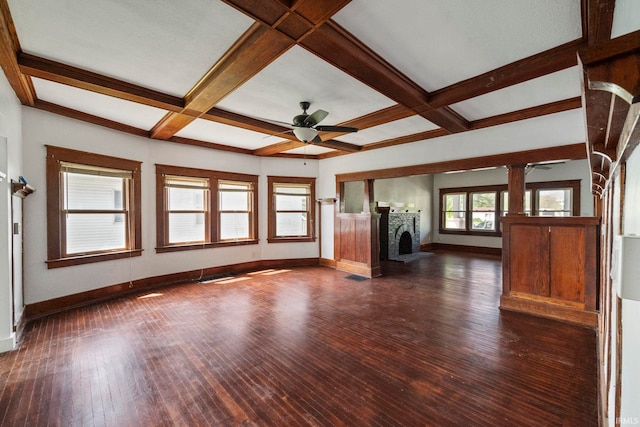 unfurnished living room featuring a ceiling fan, baseboards, a fireplace, beamed ceiling, and coffered ceiling