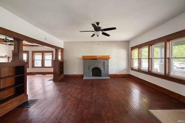 unfurnished living room featuring ceiling fan, wood finished floors, a fireplace, and baseboards