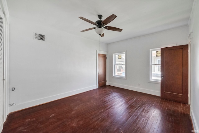unfurnished bedroom featuring dark wood-style floors, baseboards, and a ceiling fan