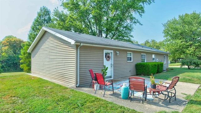 back of property with a patio and a yard