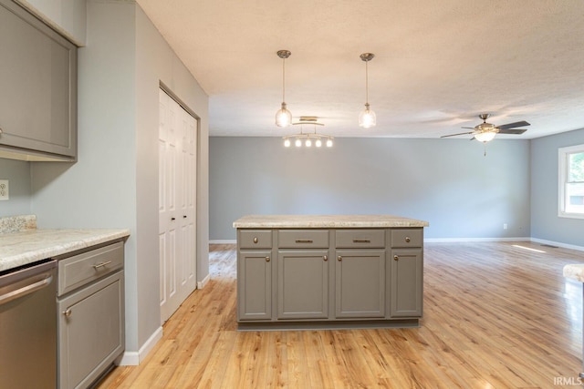 kitchen with hanging light fixtures, dishwasher, ceiling fan, and light wood-type flooring