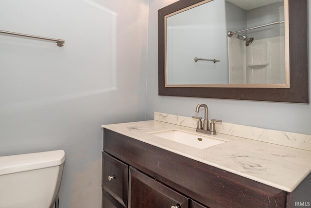 bathroom with vanity, toilet, and walk in shower