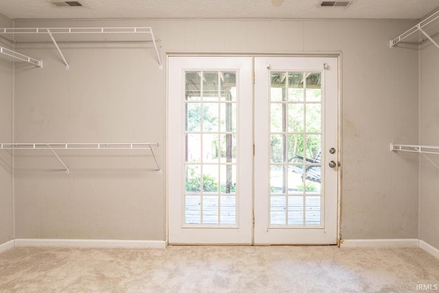 walk in closet featuring carpet flooring