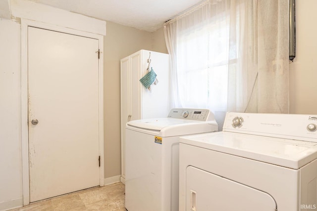 laundry room with a wealth of natural light and separate washer and dryer