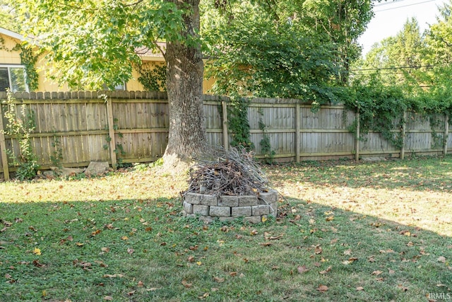 view of yard with an outdoor fire pit