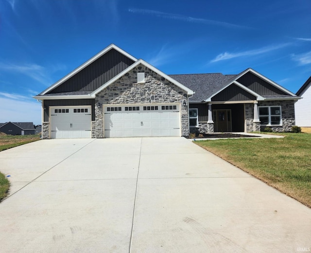 craftsman-style house featuring a front lawn and a garage