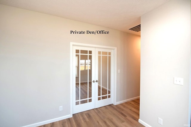 3508 Collier Dr, Lafayette, IN 47905 - unfurnished room with french doors, wood finished floors, baseboards, and a textured ceiling