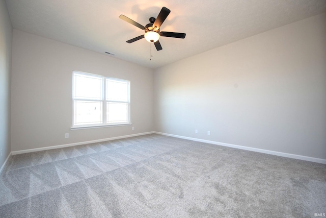 empty room with ceiling fan and carpet flooring