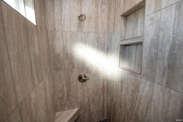 interior details with a tile shower