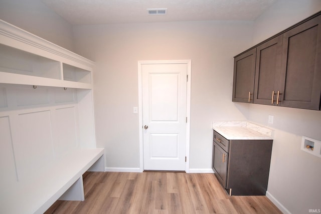 3508 Collier Dr, Lafayette, IN 47905 - laundry area with cabinet space, light wood-type flooring, hookup for a washing machine, baseboards, and a textured ceiling