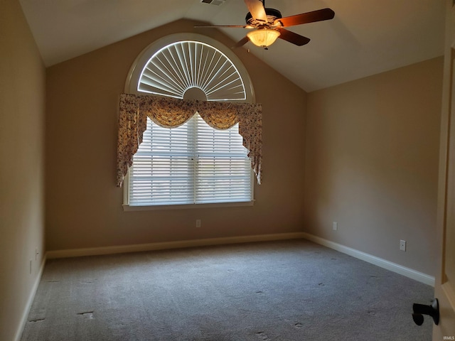 spare room featuring lofted ceiling, a ceiling fan, baseboards, and carpet floors