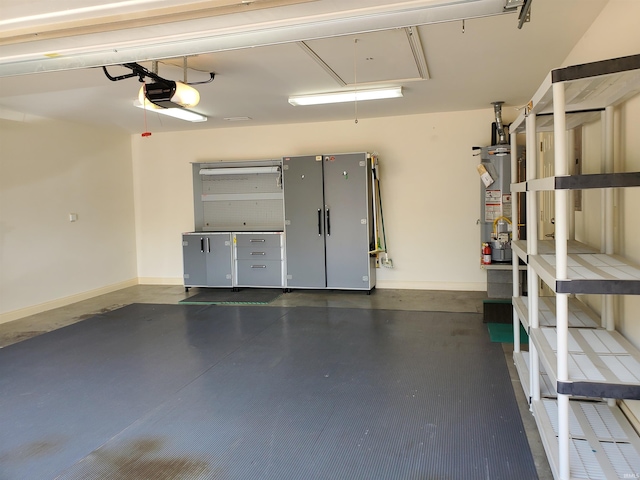 garage with a garage door opener and gas water heater