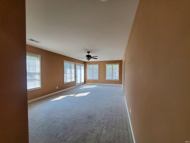 unfurnished room with ceiling fan and light colored carpet