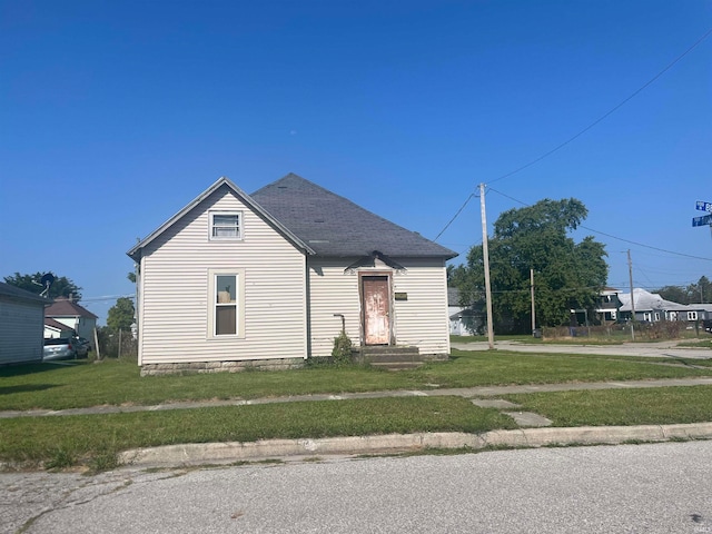 bungalow-style home with a front lawn