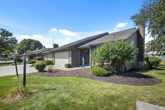 ranch-style home with a garage and a front lawn