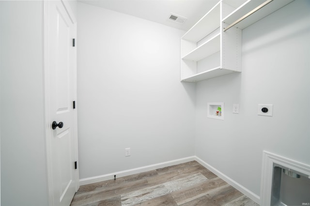 laundry area featuring hookup for a washing machine, electric dryer hookup, and light hardwood / wood-style floors