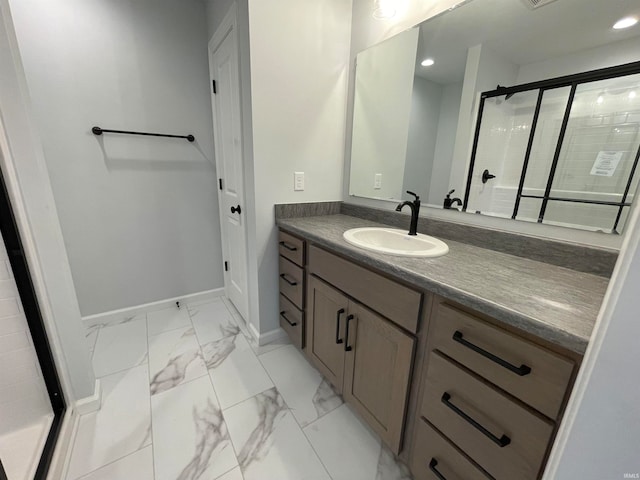 bathroom with a shower with door and vanity