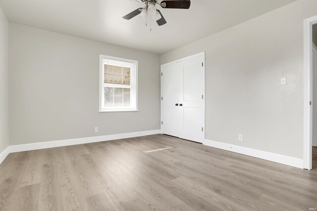 interior space featuring light hardwood / wood-style flooring, ceiling fan, and a closet