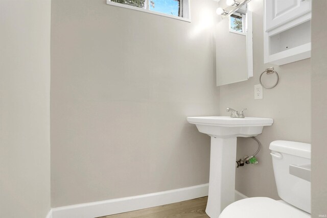 bathroom with toilet and hardwood / wood-style flooring