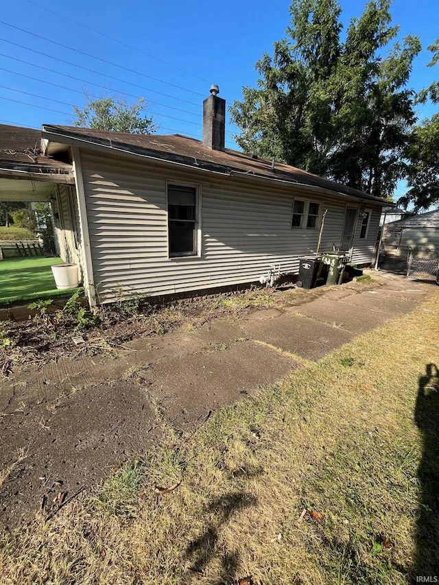 rear view of house featuring a lawn