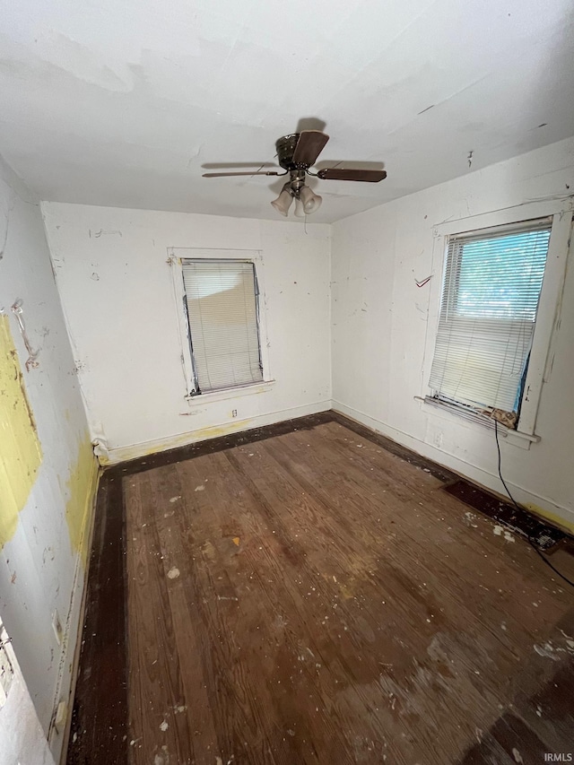 unfurnished room with ceiling fan and dark hardwood / wood-style floors