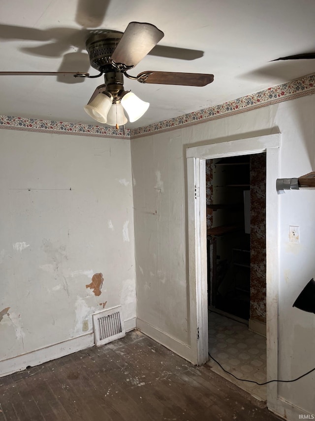 spare room featuring ceiling fan and dark hardwood / wood-style floors