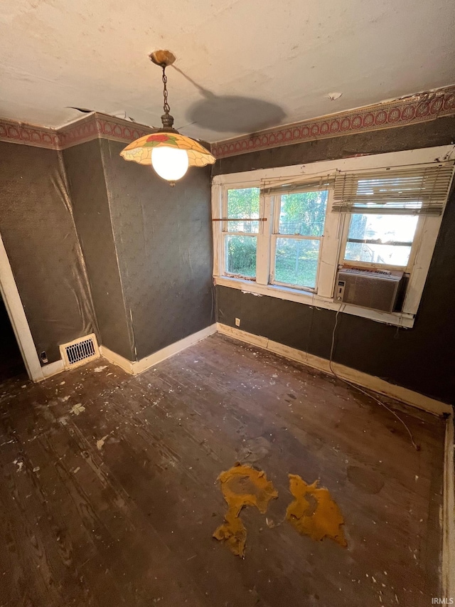 empty room featuring cooling unit, ceiling fan, and dark hardwood / wood-style floors