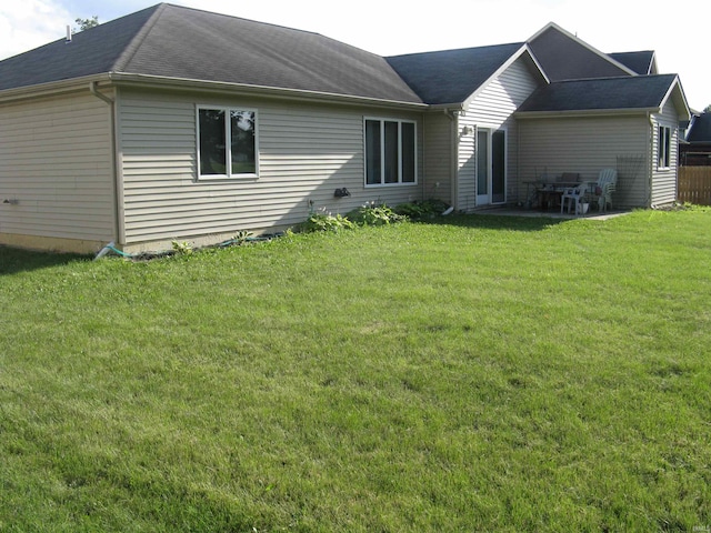 back of house with a yard and a patio area