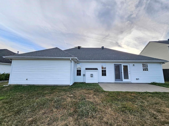 back of house featuring a yard and a patio