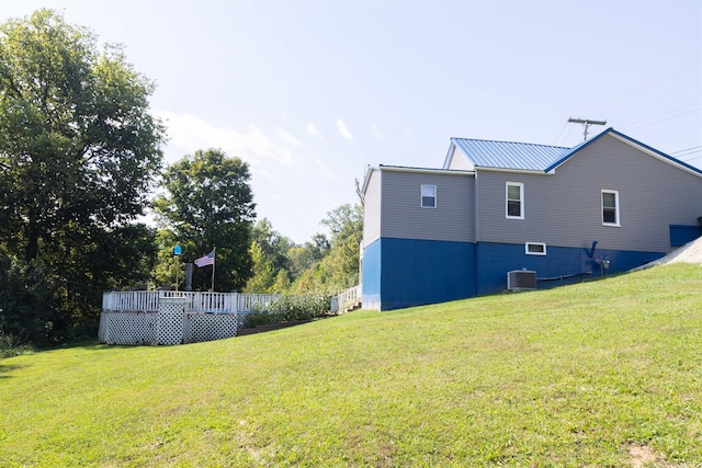 view of yard featuring central AC unit and a deck