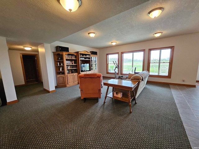 living room with tile patterned floors and a textured ceiling