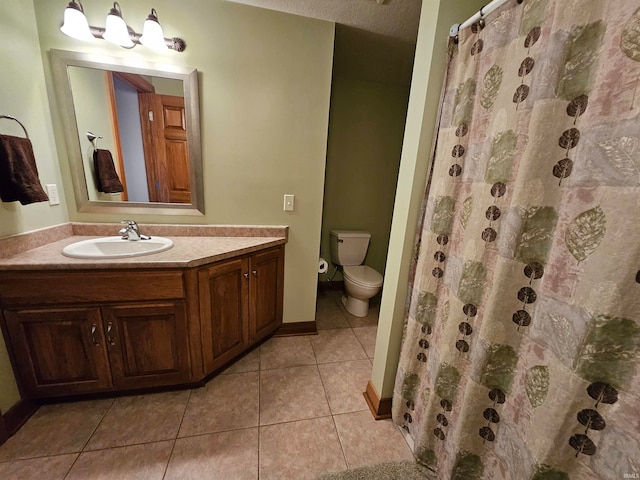 bathroom featuring a textured ceiling, vanity, walk in shower, tile patterned flooring, and toilet