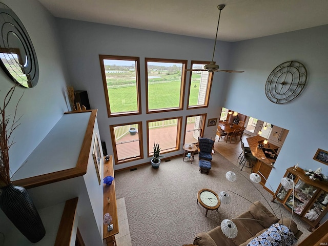 living room with ceiling fan and carpet floors