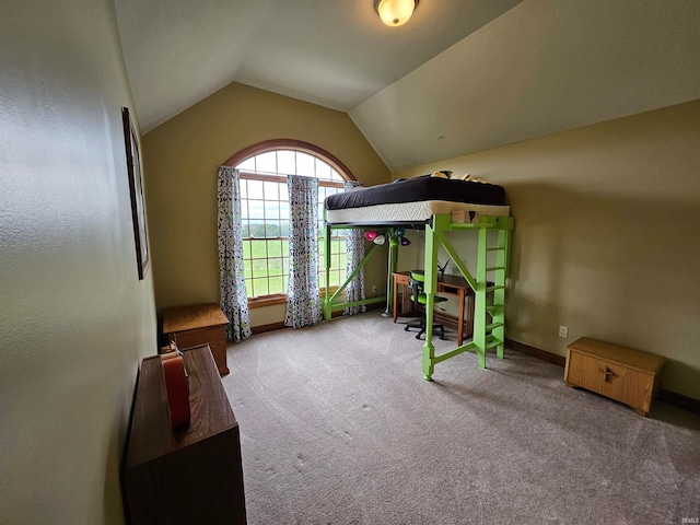 bedroom featuring lofted ceiling, stainless steel fridge, and carpet floors