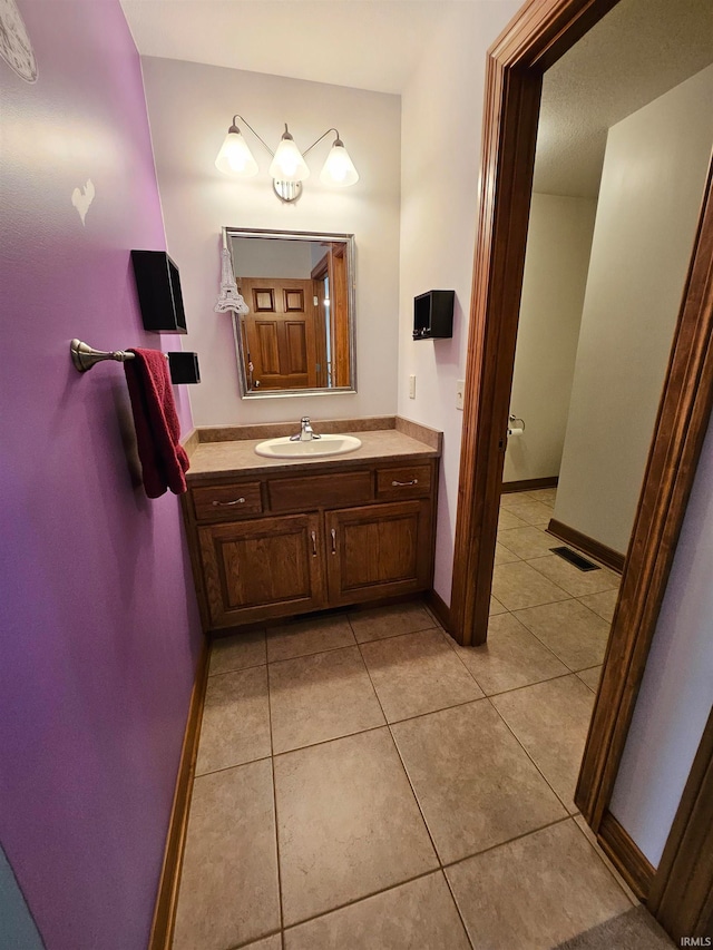 bathroom featuring tile patterned flooring and vanity